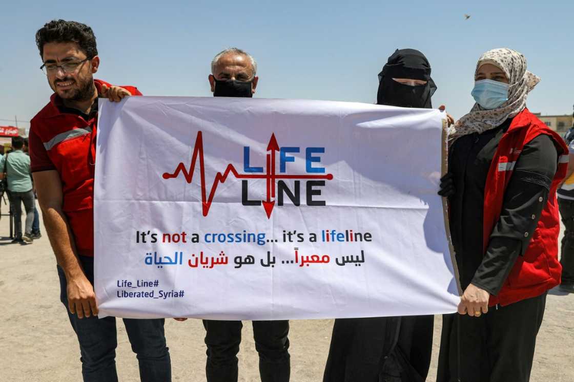 Aid workers demonstrated on July 7, seen here in Syria's Idlib province warning against any closure of the Bab al-Hawa border and holding up signs that called it a 'lifeline'