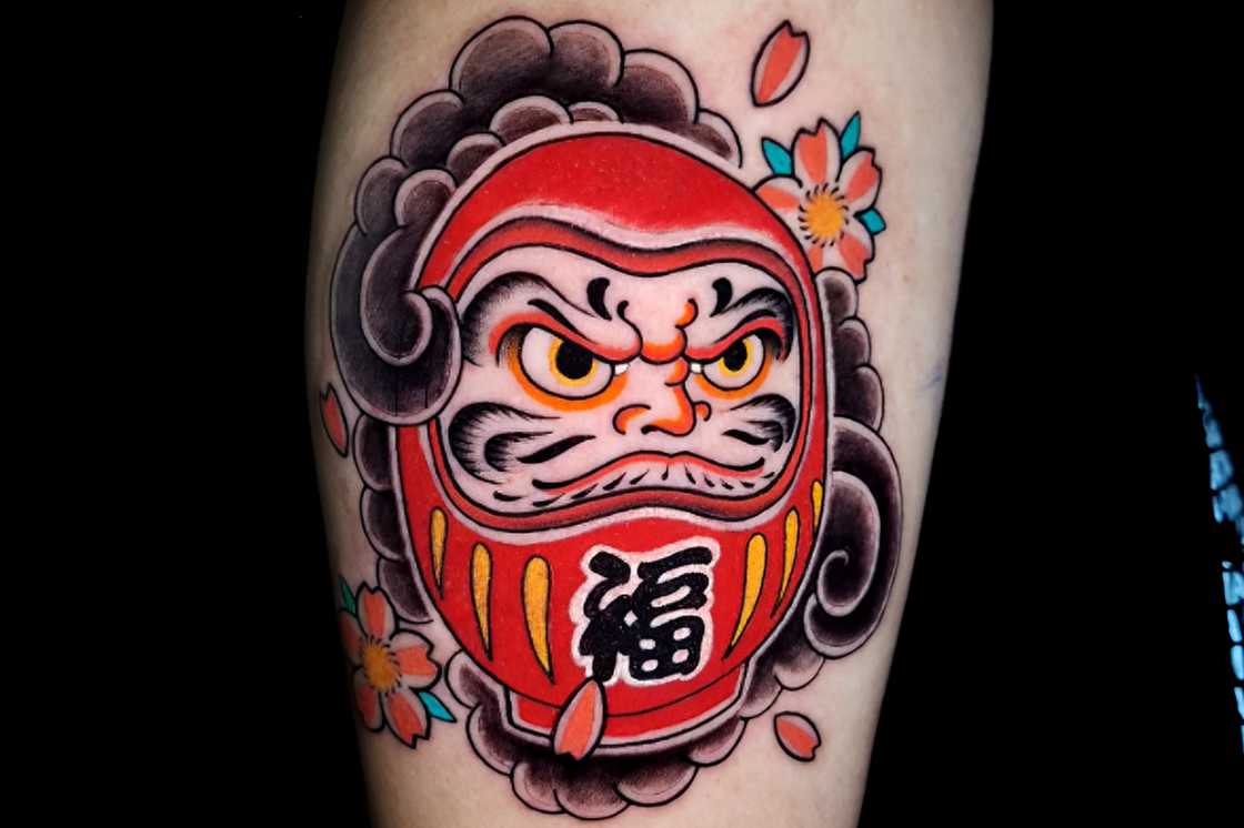 Upper arm traditional Japanese daruma doll tattoo Upper arm traditional Japanese daruma doll tattoo