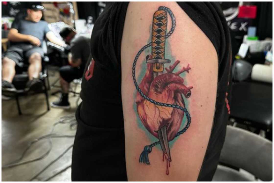 Dagger through the heart tattoo