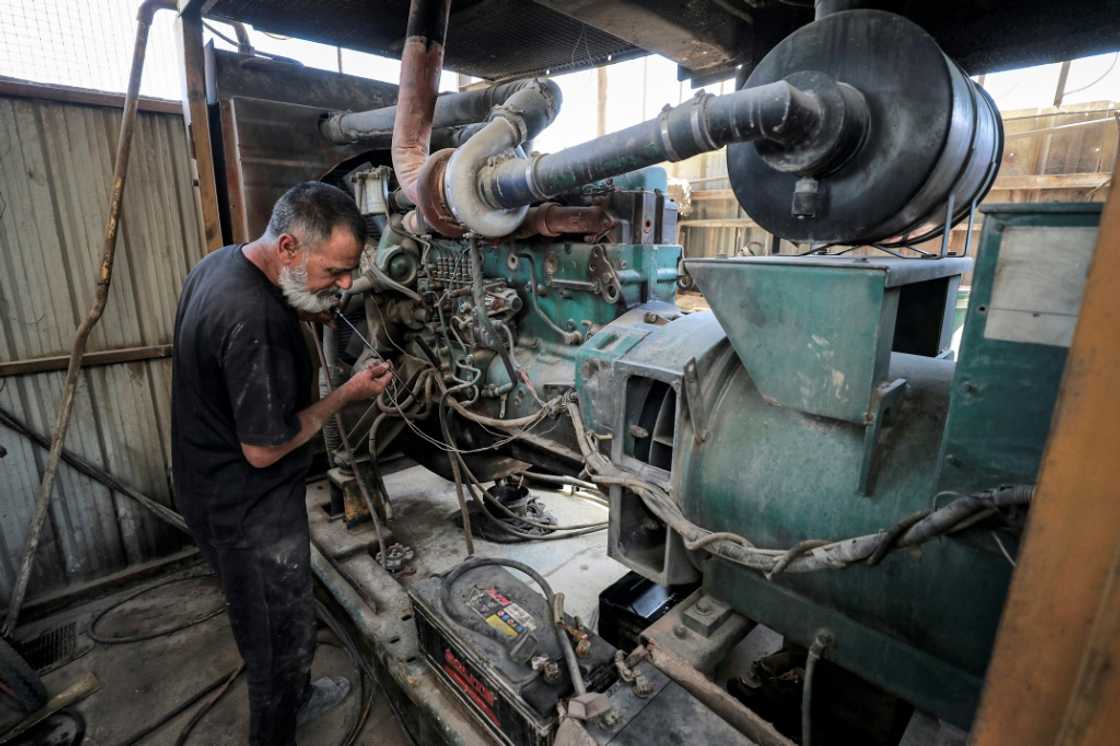 A technician checks the oil levels of a generator in Baghdad's Sadr City. The noise of privately owned generators can be heard all over Iraq as households and businesses make up for shortfalls in the national supply A technician checks the oil levels of a generator in Baghdad's Sadr City. The noise of privately owned generators can be heard all over Iraq as households and businesses make up for shortfalls in the national supply