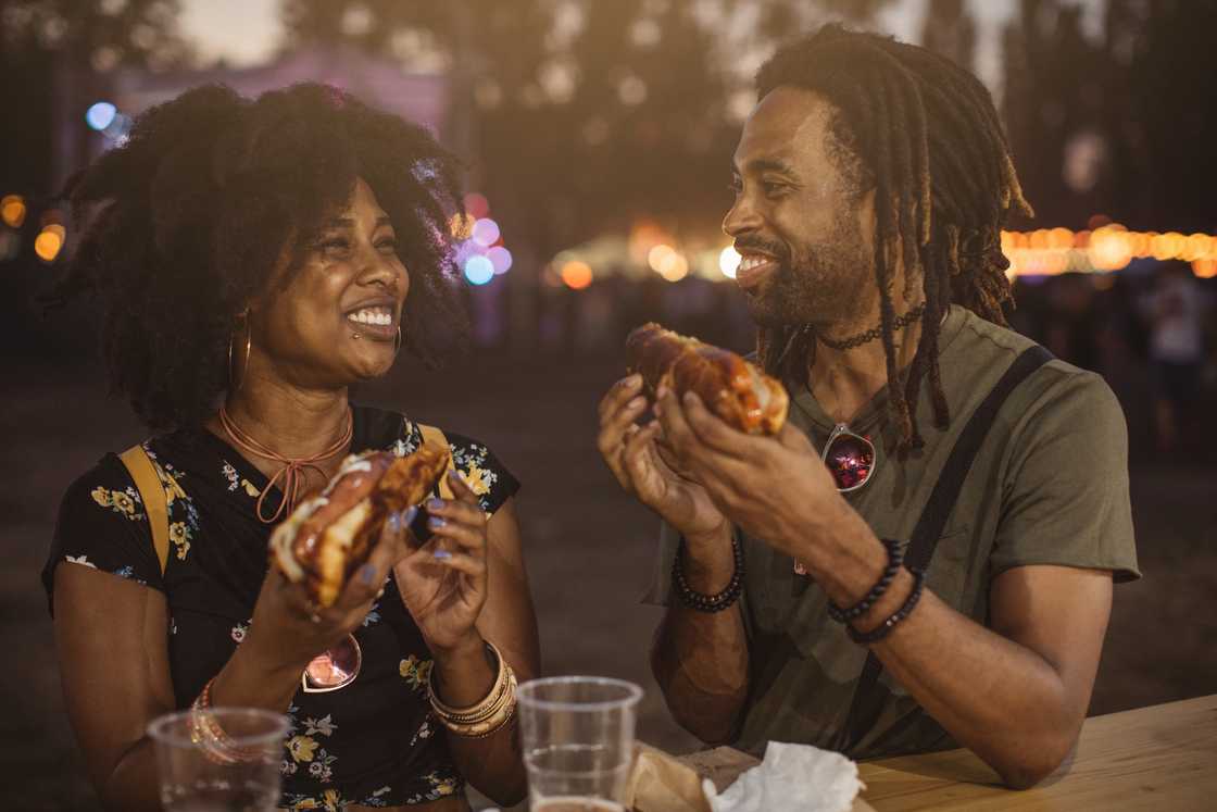 Two couples relax at a street food joint.