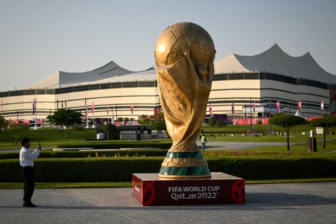 A giant replica of the World Cup trophy stands in front of the Al-Bayt Stadium where the tournament kicks off on November 20 A giant replica of the World Cup trophy stands in front of the Al-Bayt Stadium where the tournament kicks off on November 20
