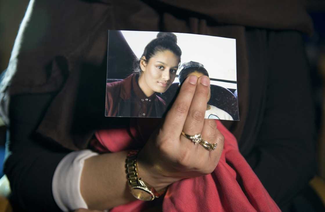 Begum's eldest sister Renu holds a photo of her as a teenager