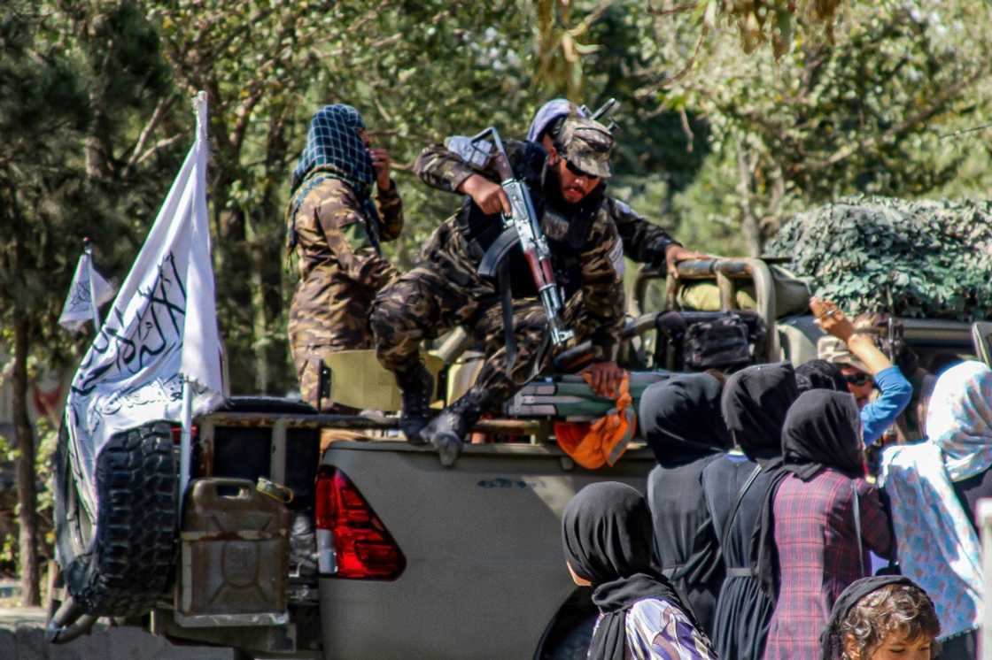 Heavily armed Taliban, some carrying rocket-propelled grenade launchers, kept watch as protesters chanted, 'Stop Hazara genocide'