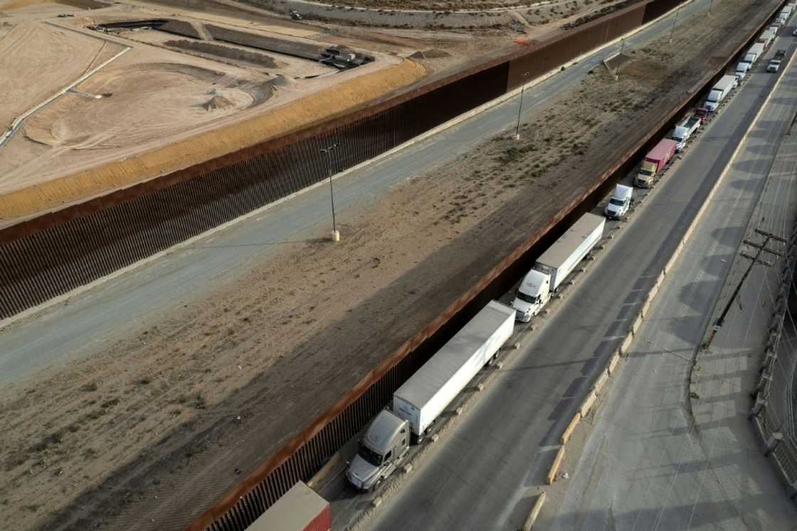 Trucks queue to enter the United States from Mexico Trucks queue to enter the United States from Mexico