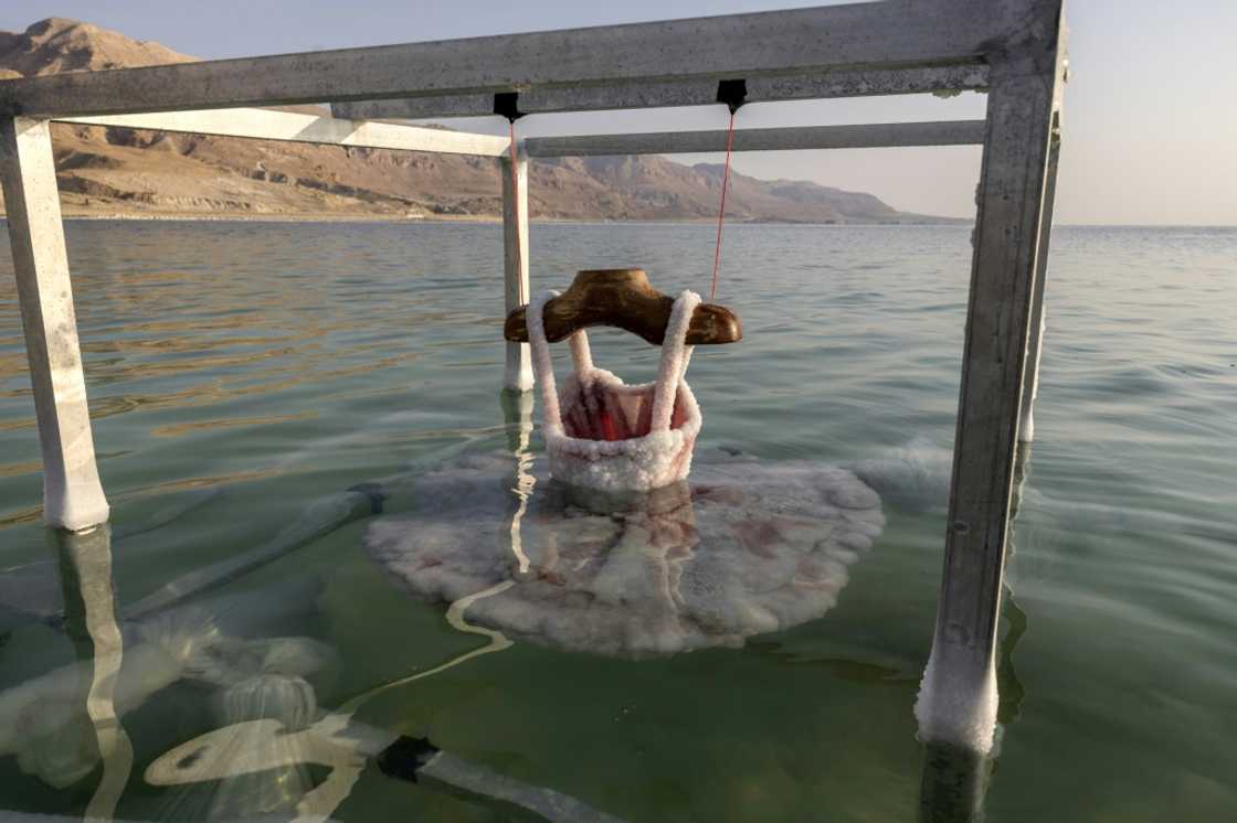 A ballerina dress is submerged in the Dead Sea and encrusted with salt, a project by Israeli artist Sigalit Landau