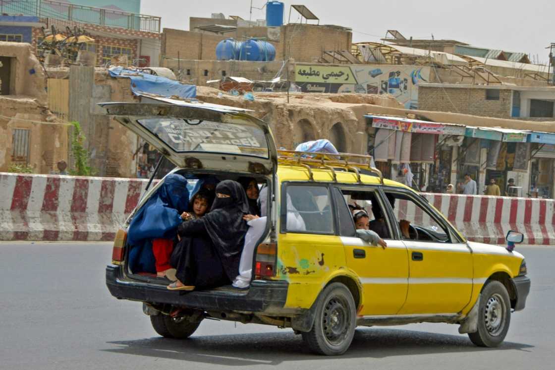 Afghan women and children commute in the back of a taxi in Kandahar Afghan women and children commute in the back of a taxi in Kandahar
