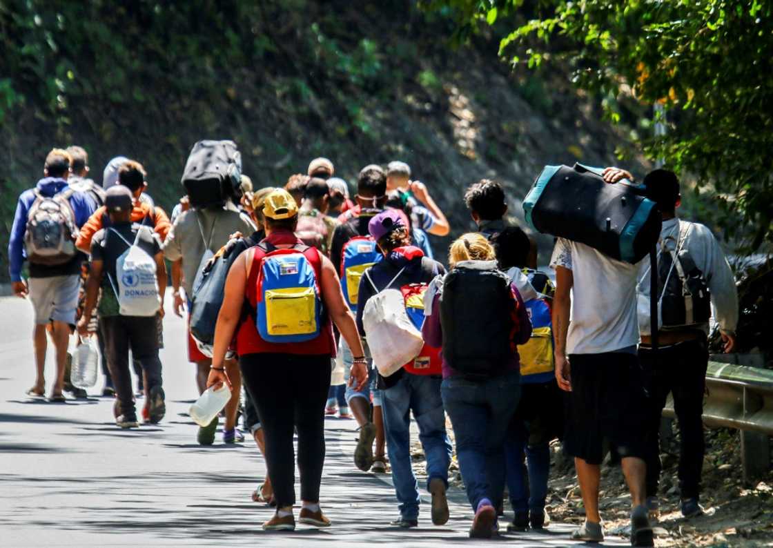 Venezuelan migrants walk along a road in Colombia in 2021 Venezuelan migrants walk along a road in Colombia in 2021