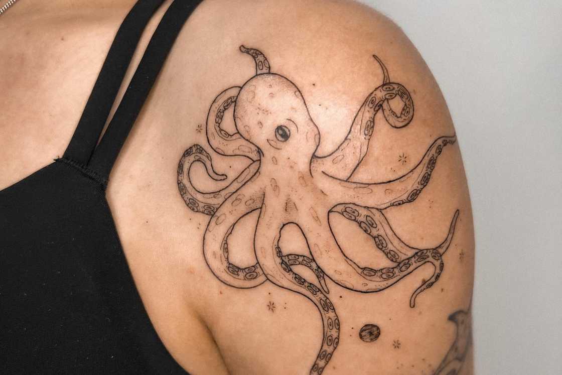 A striking octopus shoulder front tattoo A striking octopus shoulder front tattoo