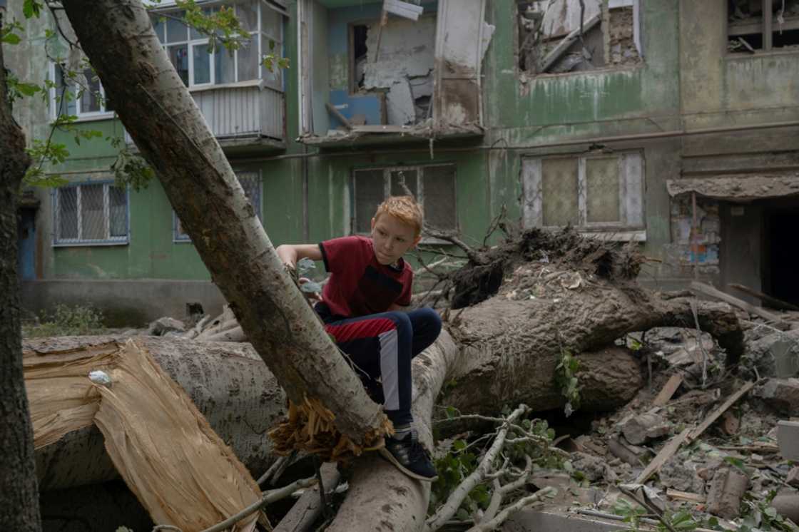 A boy sizes up the damage after a Russian strike in
Kostiantynivka, eastern Ukraine A boy sizes up the damage after a Russian strike in
Kostiantynivka, eastern Ukraine
