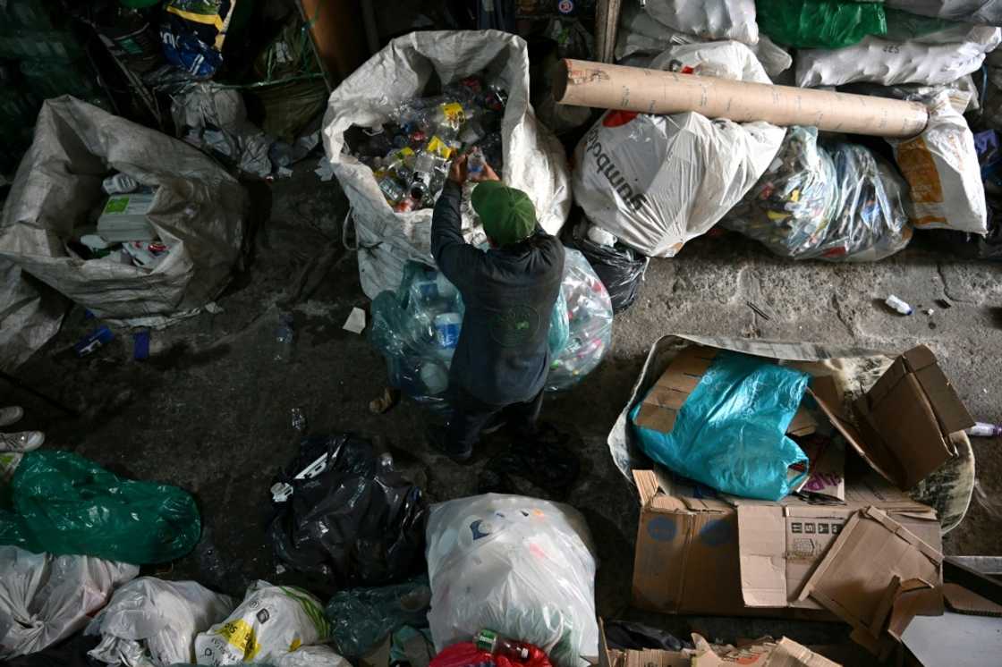 A recycler works at a recycling warehouse in Bogota: Colombian cities have no public recycling systems A recycler works at a recycling warehouse in Bogota: Colombian cities have no public recycling systems