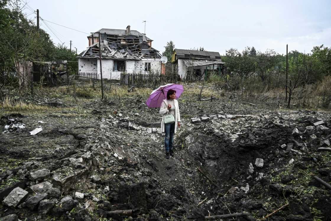 A woman stands in front of a destroyed house, in Kramatorsk, Donetsk region, on September 12, 2022 A woman stands in front of a destroyed house, in Kramatorsk, Donetsk region, on September 12, 2022