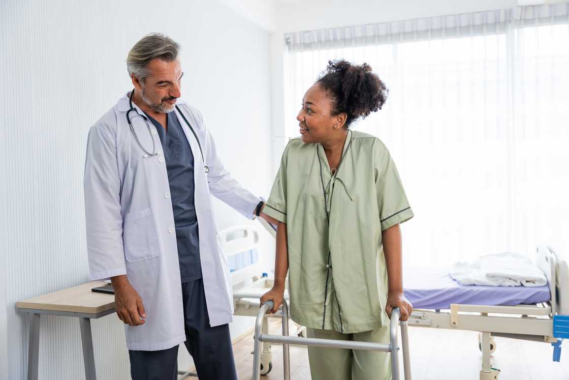 A young black woman patient takes her first steps A young black woman patient takes her first steps