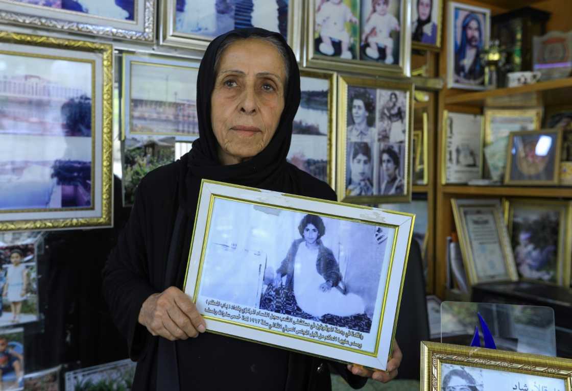 Photographer and ex-political prisoner Samira Mazaal, 77, poses with a framed picture of her on a hospital bed after being tortured Photographer and ex-political prisoner Samira Mazaal, 77, poses with a framed picture of her on a hospital bed after being tortured