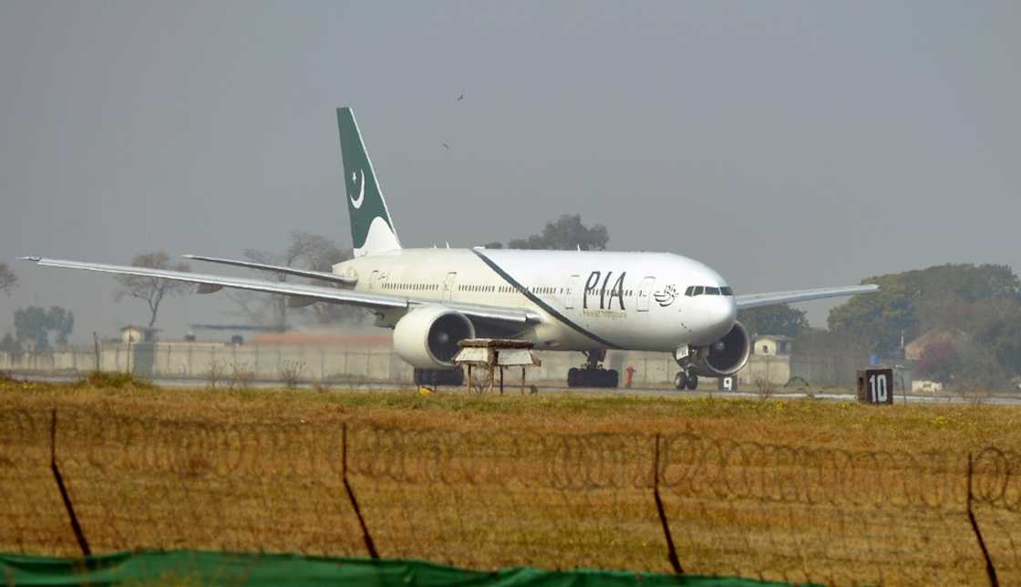 A Pakistan International Airline plane taxis on the runway A Pakistan International Airline plane taxis on the runway