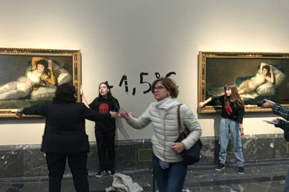 Two climate activists were detained after each glued a hand to a painting in the Madrid museum