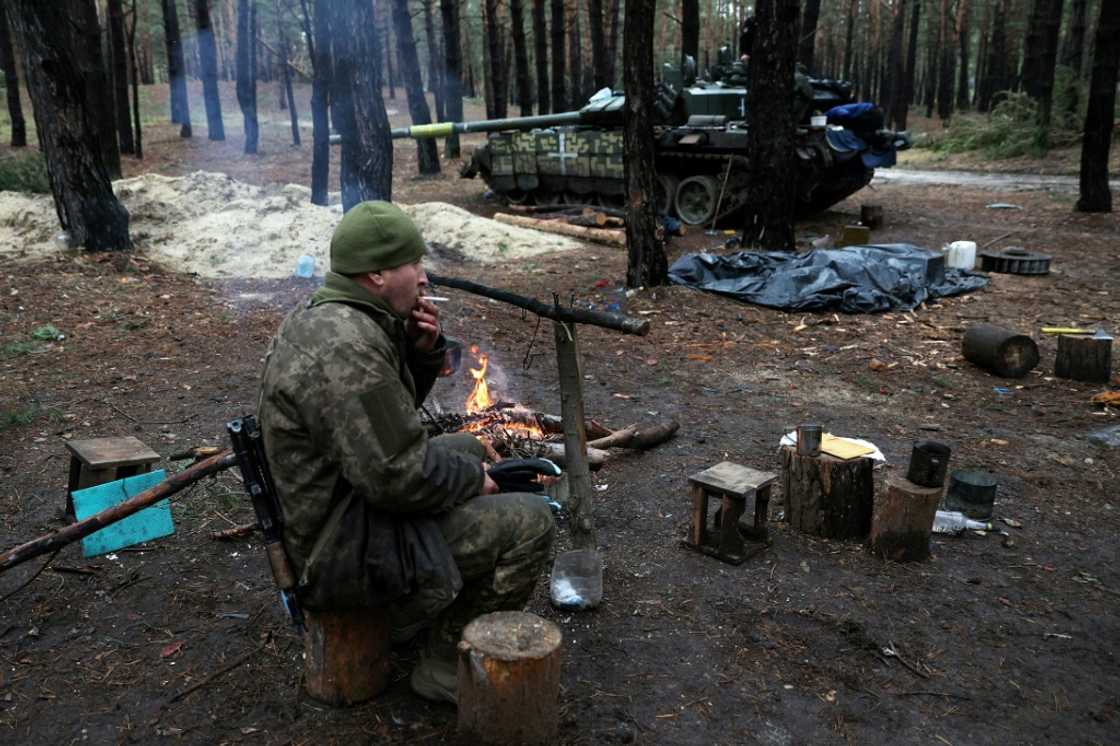 A Ukrainian serviceman smokes a cigarette in a forest near the front line in the Kharkiv region A Ukrainian serviceman smokes a cigarette in a forest near the front line in the Kharkiv region