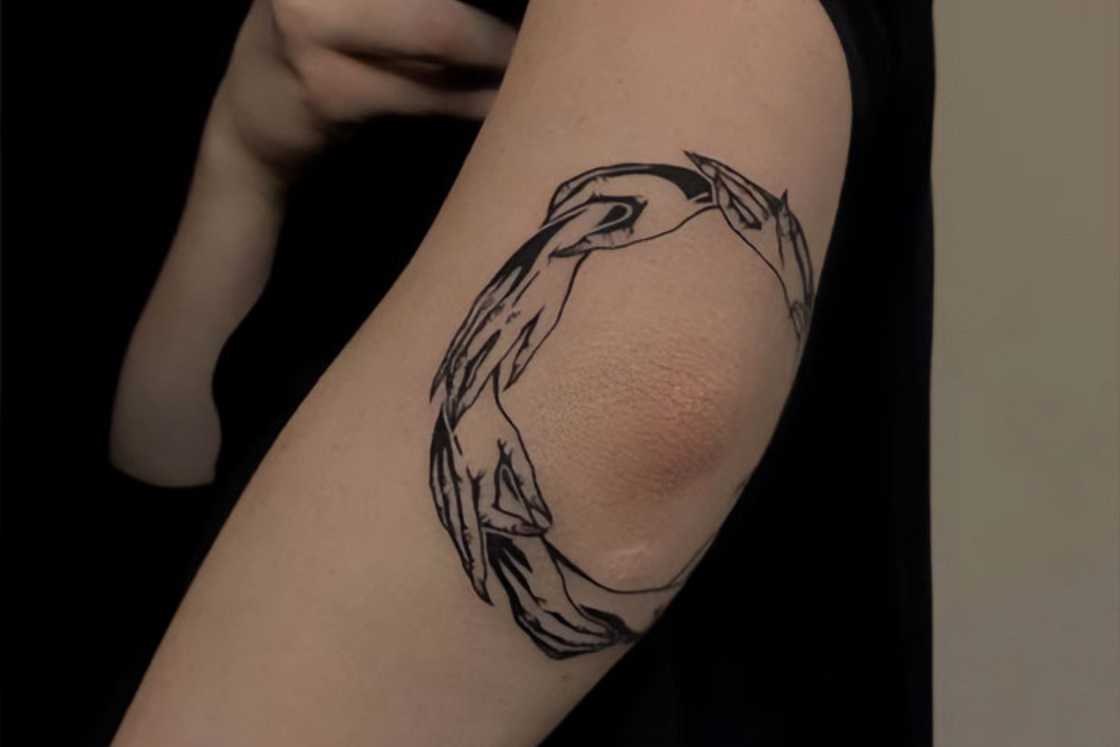 Black and white hands circle elbow tattoo Black and white hands circle elbow tattoo