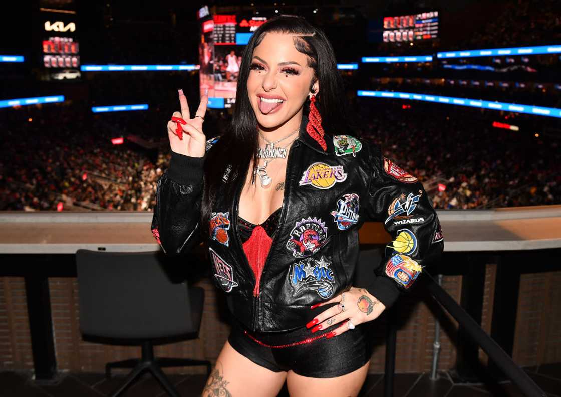 Rapper Tay Money poses at the Brooklyn Nets v Atlanta Hawks game.