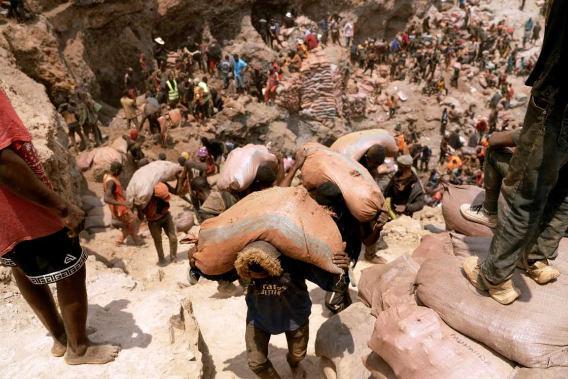 Artisanal miners carry sacks of ore at the Shabara artisanal mine in the Democratic Republic of Congo in October 2022