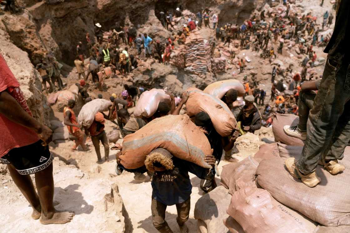 Artisanal miners carry sacks of ore at the Shabara artisanal mine in the Democratic Republic of Congo in October 2022 Artisanal miners carry sacks of ore at the Shabara artisanal mine in the Democratic Republic of Congo in October 2022