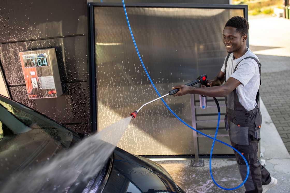 A man washing cars in the car wash A man washing cars in the car wash