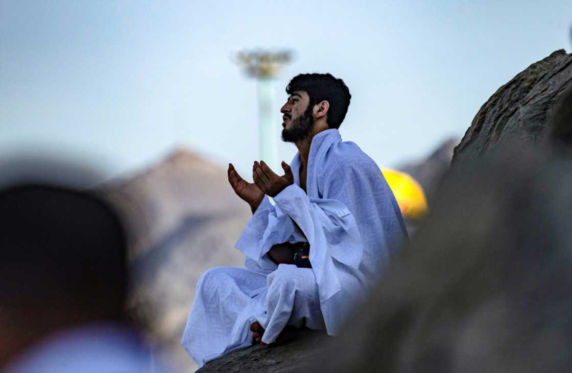 A Muslim pilgrim prays atop Mount Arafat, southeast of the holy city of Mecca, during the climax of the Hajj pilgrimage A Muslim pilgrim prays atop Mount Arafat, southeast of the holy city of Mecca, during the climax of the Hajj pilgrimage
