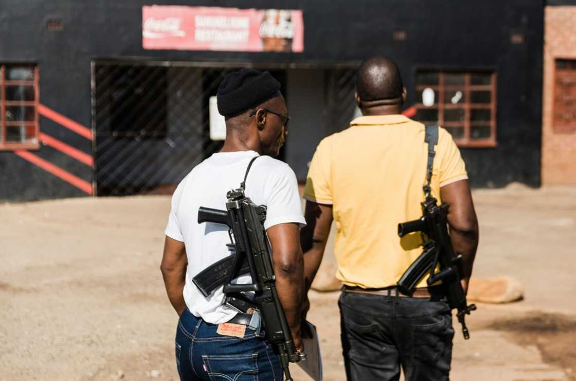 Security guards stand outside the scene of a shooting were four people died near Pietermaritzburg Security guards stand outside the scene of a shooting were four people died near Pietermaritzburg