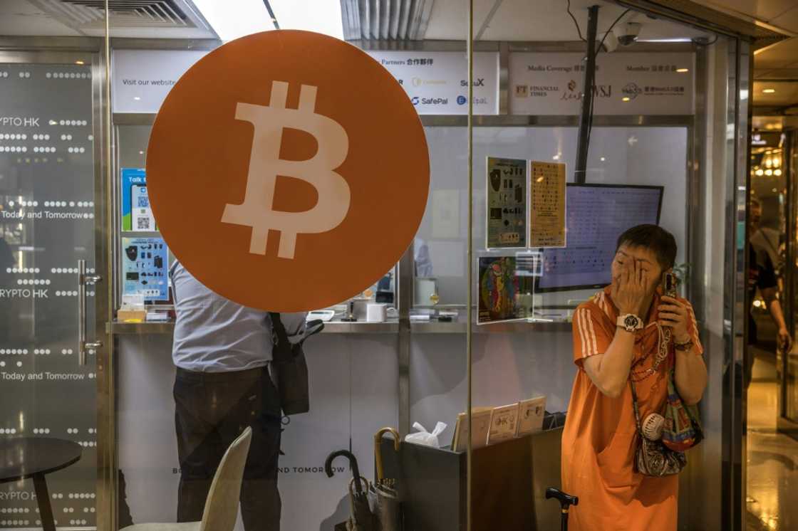 A woman uses her phone outside a cryptocurrency exchange in Hong Kong A woman uses her phone outside a cryptocurrency exchange in Hong Kong
