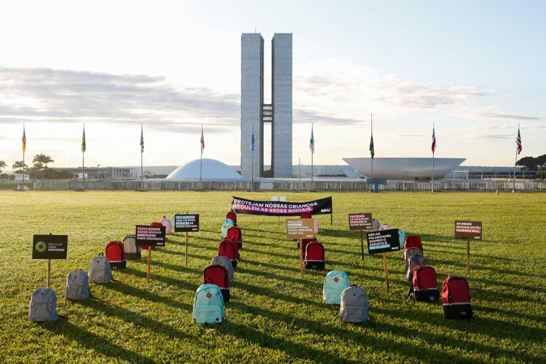 Backpacks representing victims of school massacres, which activists say have increased in Brazil amid lack of regulation of extremism social media, are seen during a protest in front of the National Congress in the capital Brasilia