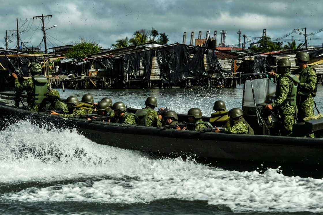 A Colombian navy patrol in the waters around Buenaventura, where rival gangs have turned the major port city into a living nightmare for residents A Colombian navy patrol in the waters around Buenaventura, where rival gangs have turned the major port city into a living nightmare for residents