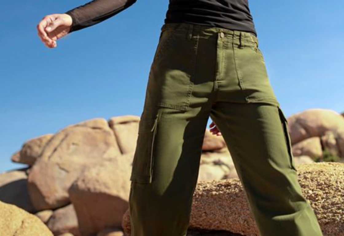 A woman wearing a pair of green cargo pants A woman wearing a pair of green cargo pants