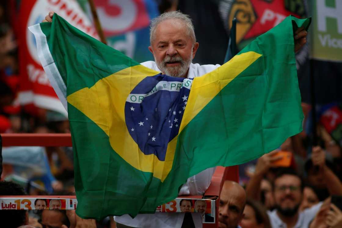 Brazil's former president Luiz Inacio Lula da Silva holds a Brazilian national flag during a re-election campaign rally in Guarulhos, Sao Paulo state, Brazil in October 2022 Brazil's former president Luiz Inacio Lula da Silva holds a Brazilian national flag during a re-election campaign rally in Guarulhos, Sao Paulo state, Brazil in October 2022