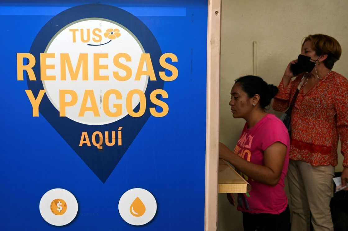 A woman in the Honduran capital Tegucigalpa withdraws a remittance sent by relatives living in the United States A woman in the Honduran capital Tegucigalpa withdraws a remittance sent by relatives living in the United States
