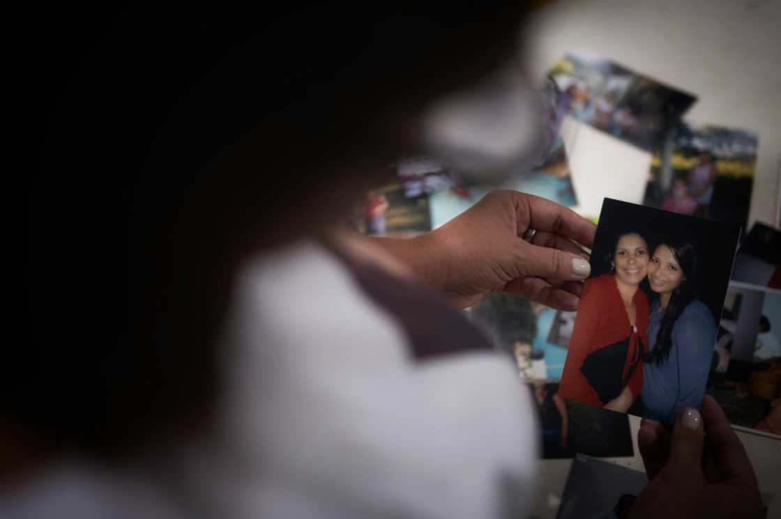 Tania de Oliveira shows a picture of her cousin Nathalia, one of the victims who remain missing five years after a mine dam collapse in the Brazilian town of Brumadinho