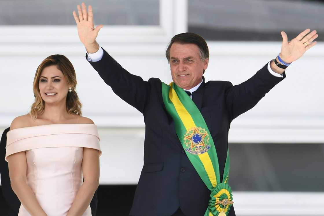 In January 2019, Brazil's new president Jair Bolsonaro (R) waves to supporters next to his wife Michelle after receiveing the presidential sash from outgoing president Michel Temer at the presidential palace in Brasilia In January 2019, Brazil's new president Jair Bolsonaro (R) waves to supporters next to his wife Michelle after receiveing the presidential sash from outgoing president Michel Temer at the presidential palace in Brasilia