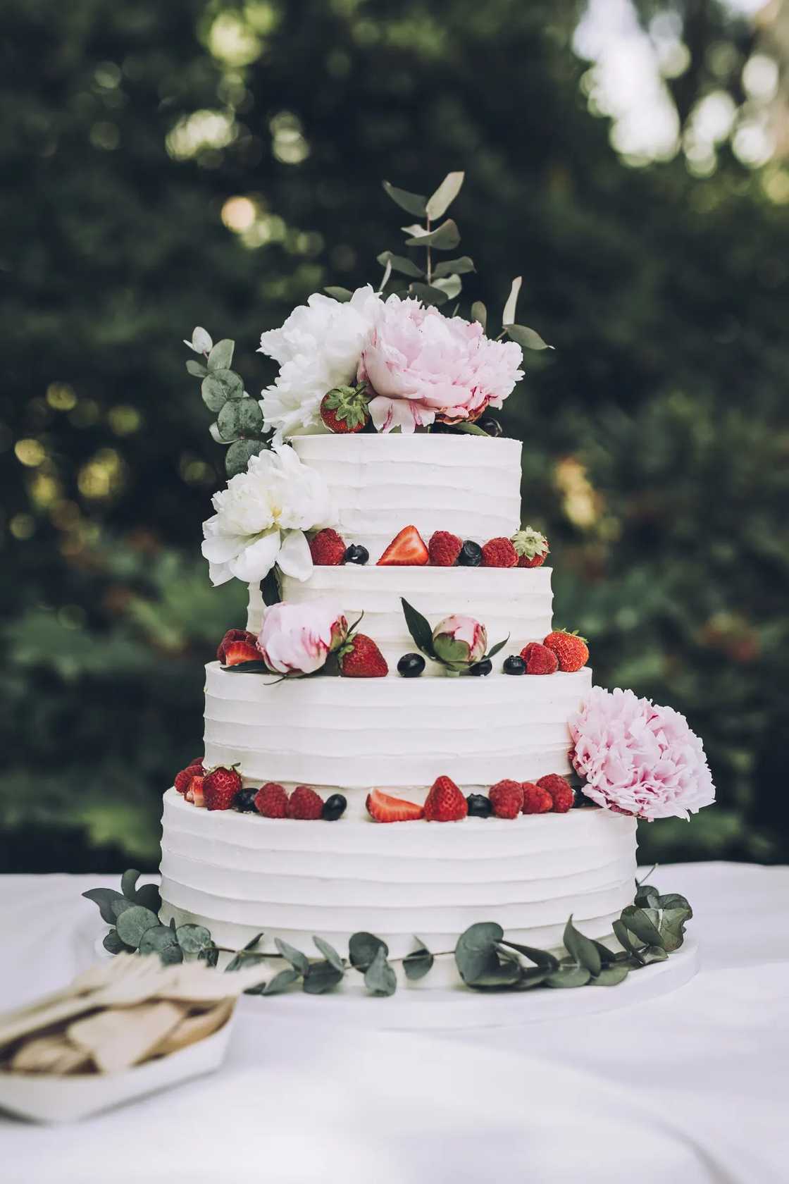 A white wedding cake with fruit