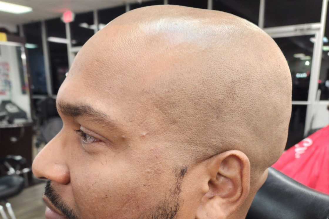 A man with a clean shave is in a room A man with a clean shave is in a room