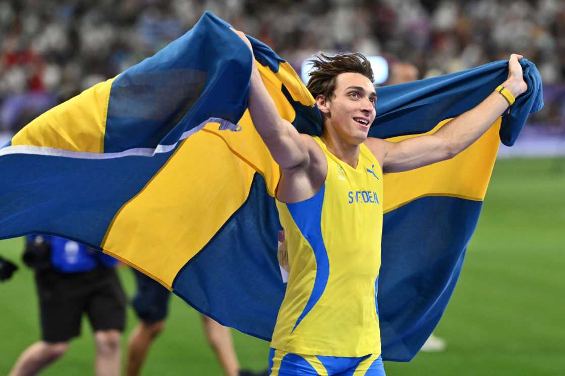 Armand Duplantis celebrates after winning the pole vault final at Paris 2024.