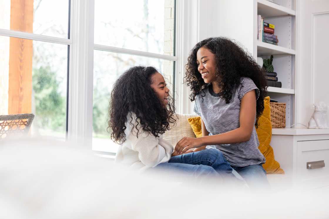 Two siblings talking indoors Two siblings talking indoors