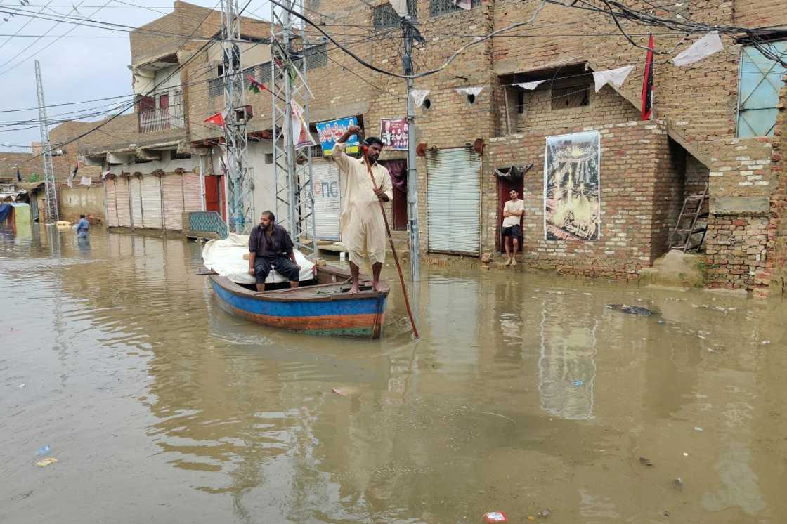 A resident makes his way by boat along a waterlogged street in Sukkur, Sindh province A resident makes his way by boat along a waterlogged street in Sukkur, Sindh province