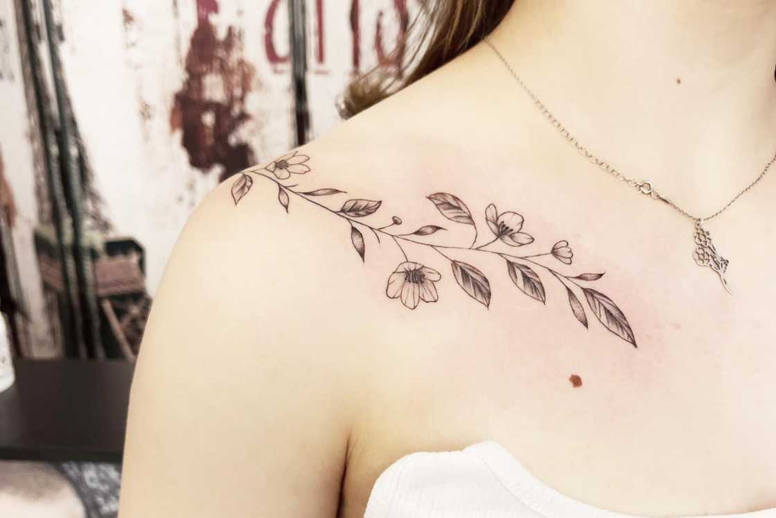 A black and grey vine shoulder front tattoo A black and grey vine shoulder front tattoo