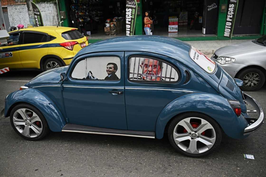 Fans of Brazilian President Jair Bolsonaro have taken to driving cars with images of him as a driver and his rival, leftist Luiz Inacio Lula da Silva, as a prisoner behind bars Fans of Brazilian President Jair Bolsonaro have taken to driving cars with images of him as a driver and his rival, leftist Luiz Inacio Lula da Silva, as a prisoner behind bars