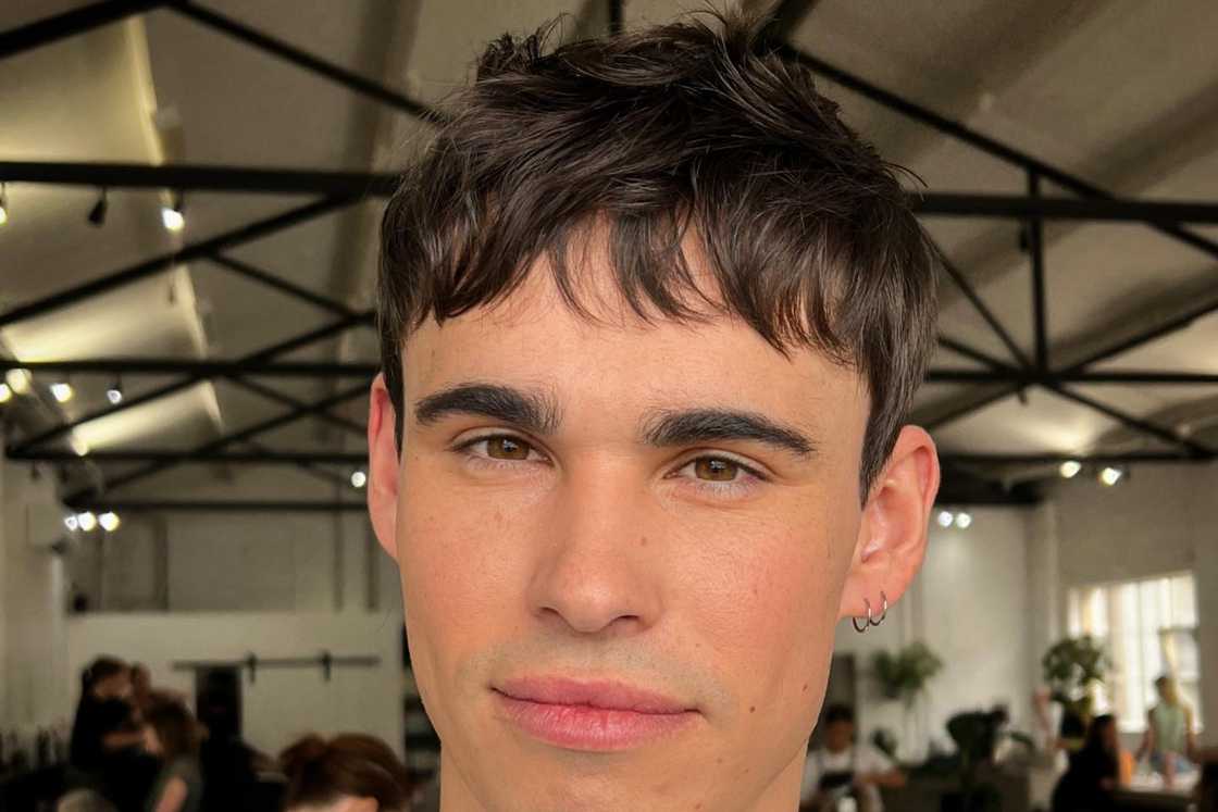 A youthful man rocks a textured fringe hairstyle A youthful man rocks a textured fringe hairstyle