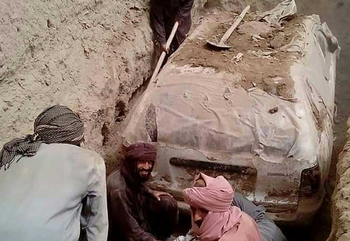 The white Toyota Corolla was buried in a village garden in Zabul province by Taliban official Abdul Jabbar Omari, who ordered it to be dug up this week.
In this undated handout picture released by Taliban media officials on July 7, 2022, Taliban members dig up a Toyota Corolla, used by Taliban founder Mullah Omar to escape being targetted by US forces after 9/11, at Omrazai village in Seyora district of Zabul province. The white Toyota Corolla was buried in a village garden in Zabul province by Taliban official Abdul Jabbar Omari, who ordered it to be dug up this week.
In this undated handout picture released by Taliban media officials on July 7, 2022, Taliban members dig up a Toyota Corolla, used by Taliban founder Mullah Omar to escape being targetted by US forces after 9/11, at Omrazai village in Seyora district of Zabul province.