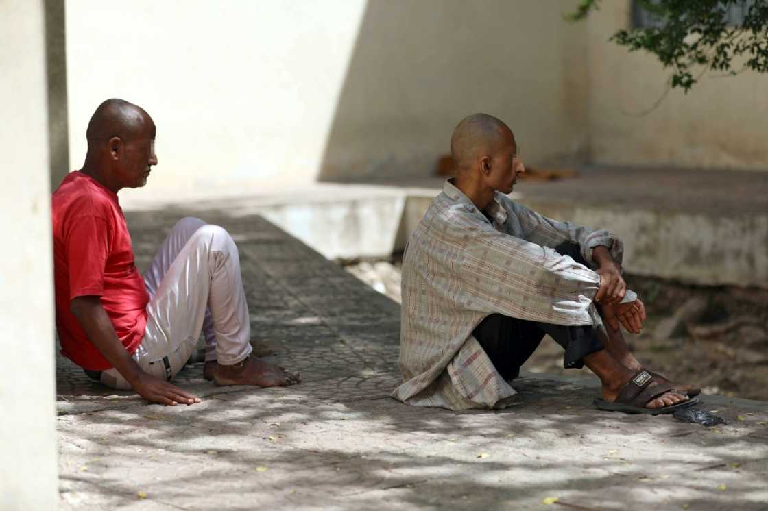 Patients at a psychiatric hospital sit outdoors in the shade in Yemen's third city of Taez Patients at a psychiatric hospital sit outdoors in the shade in Yemen's third city of Taez