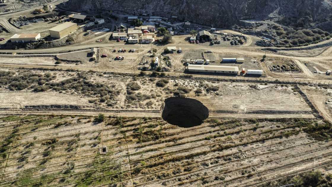 The sinkhole in Chile's Atacama deser is 32 meters (104 feet) across and twice as deep The sinkhole in Chile's Atacama deser is 32 meters (104 feet) across and twice as deep