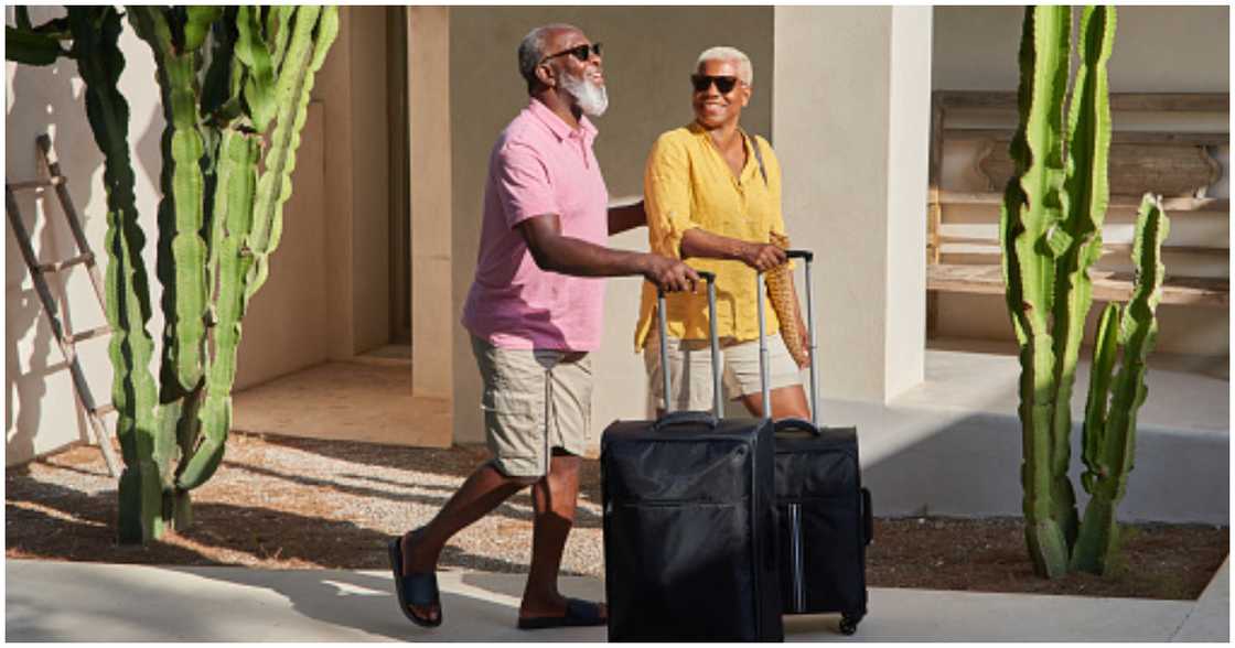 A couple pack their bags to travel A couple pack their bags to travel