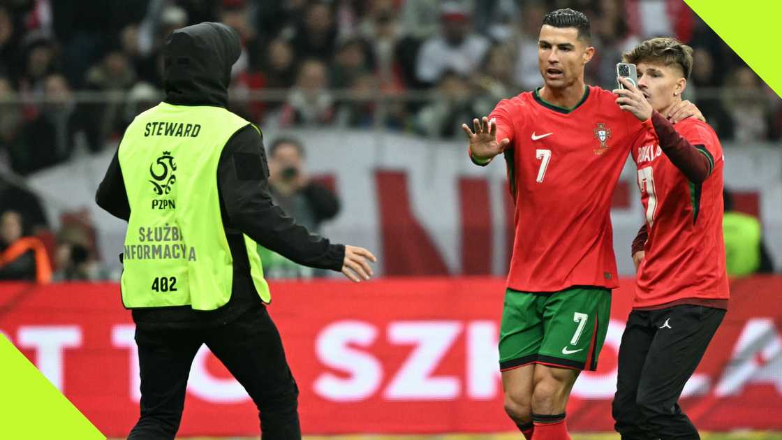 Al-Nassr talisman Cristiano Ronaldo pleads with steward to allow pitch invader to take a selfie with him during Portugal's Nations League clash with Poland on October 12, 2024.