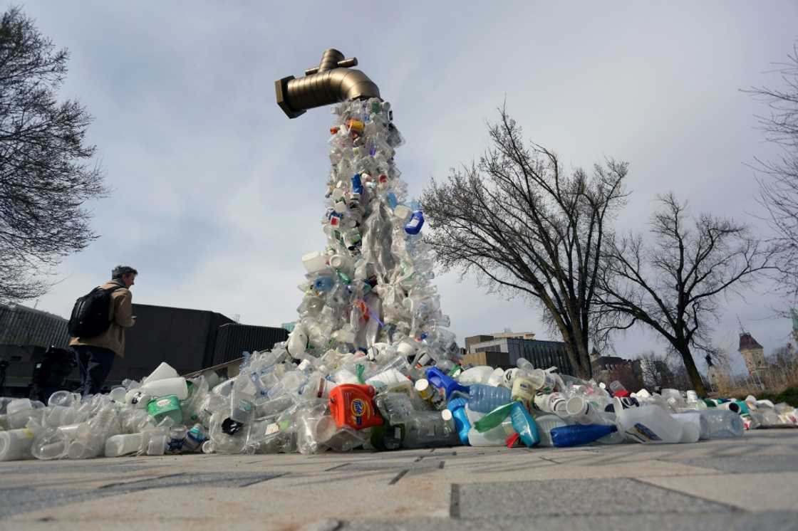 A sculpture titled "Giant Plastic Tap" by Canadian artist Benjamin Von Wong is displayed outside the fourth session of the UN Intergovernmental Negotiating Committee on Plastic Pollution in Ottawa, Canada, on April 23, 2024